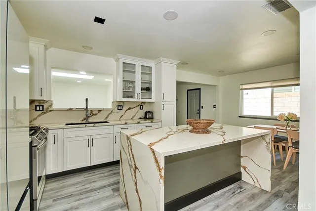 a kitchen with sink stove and cabinets