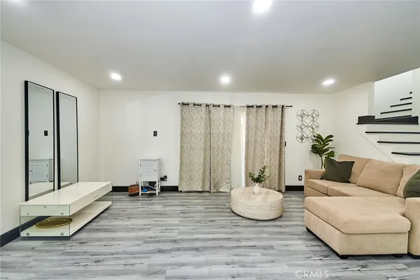 a living room with furniture and a potted plant