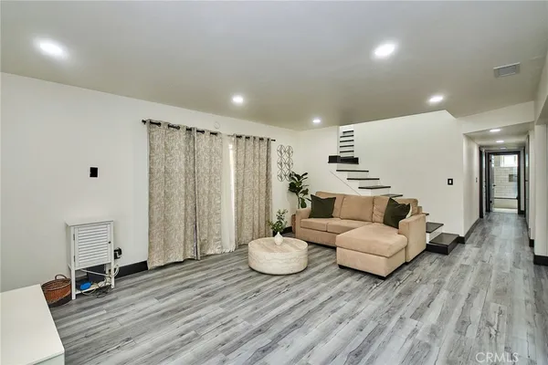 a spacious bedroom with a bed and a couch