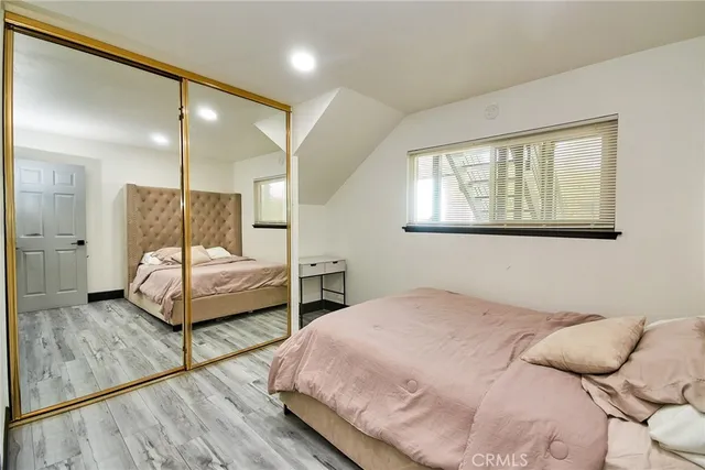 a bedroom with a bed and a large mirror