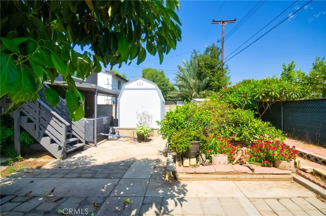 a view of backyard with a garden and outdoor seating