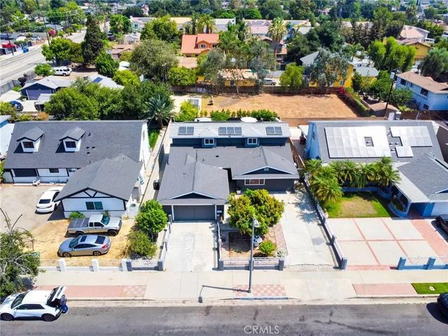 an aerial view of residential houses with street