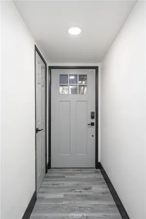 an empty room with wooden floor and closet