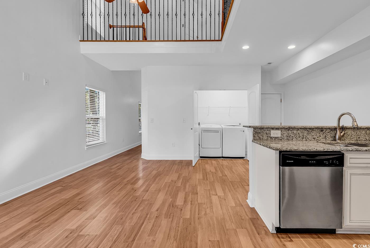 327-a&b Sparrow Drive Surfside Beach, SC 29575 - Photo 21 of 33 Kitchen featuring stainless steel dishwasher, separate washer and dryer, light stone countertops, white cabinets, and ceiling fan