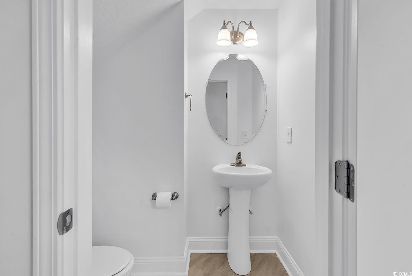 327-a&b Sparrow Drive Surfside Beach, SC 29575 - Photo 23 of 33 Half bathroom with baseboards and toilet