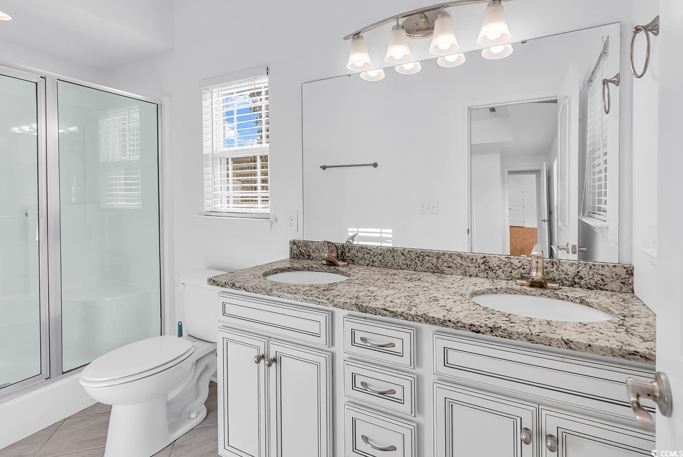 327-a&b Sparrow Drive Surfside Beach, SC 29575 - Photo 25 of 33 Full bath with double vanity and a shower stall