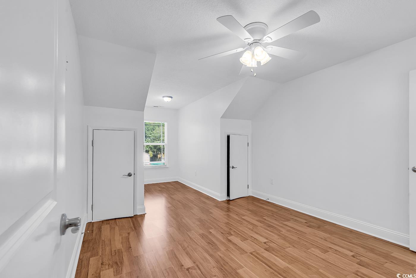 327-a&b Sparrow Drive Surfside Beach, SC 29575 - Photo 27 of 33 Bonus room with light wood-style flooring, a ceiling fan, and lofted ceiling