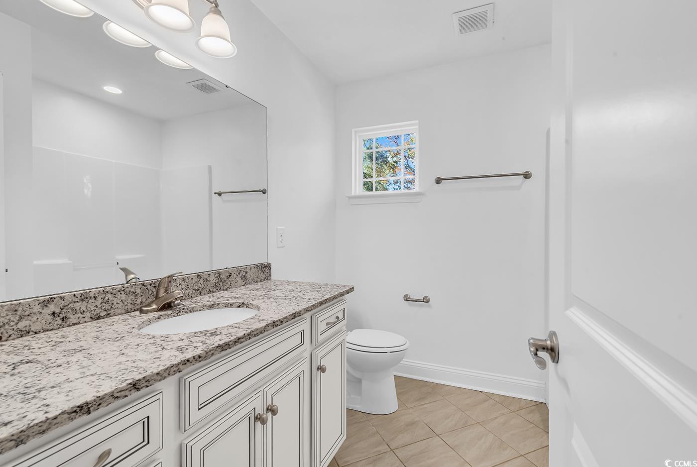 327-a&b Sparrow Drive Surfside Beach, SC 29575 - Photo 28 of 33 Full bathroom featuring vanity and light tile patterned floors