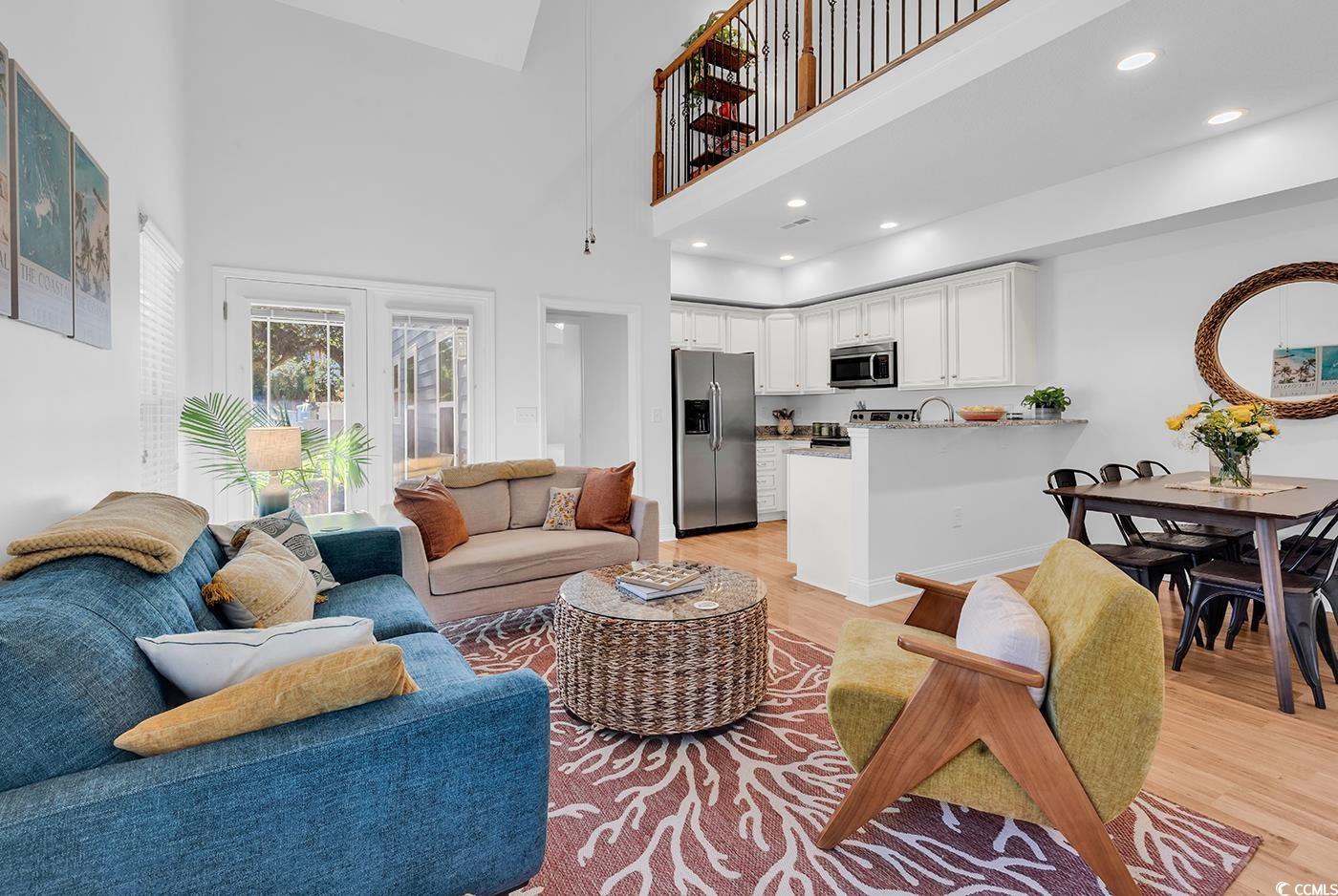 327-a&b Sparrow Drive Surfside Beach, SC 29575 - Photo 3 of 33 Living room featuring light wood-style floors, a high ceiling, and recessed lighting