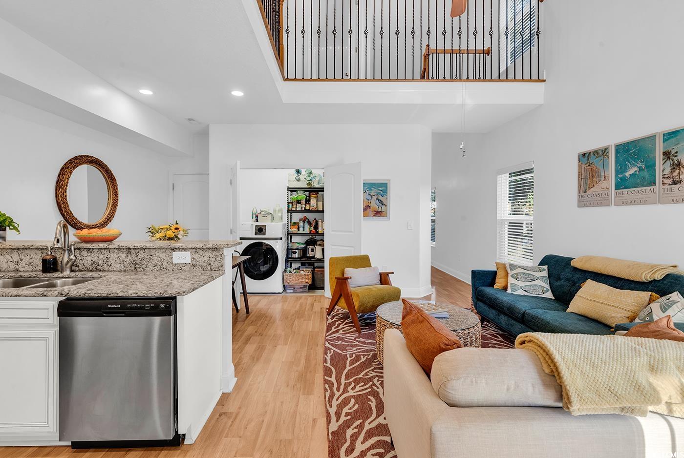 327-a&b Sparrow Drive Surfside Beach, SC 29575 - Photo 6 of 33 Living area with light wood-type flooring, a high ceiling, washer / dryer, and recessed lighting