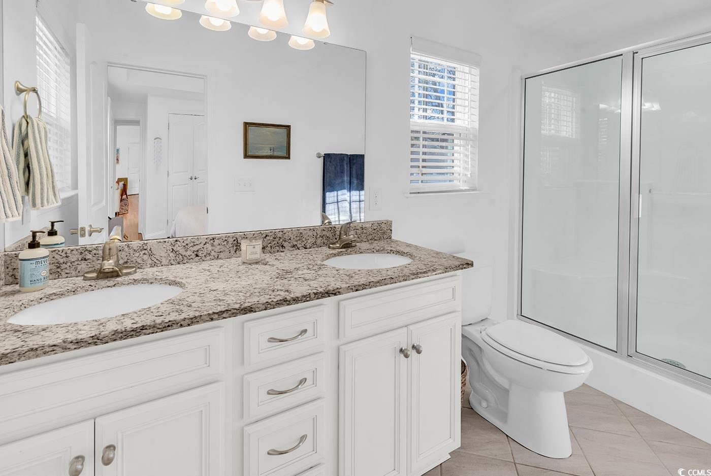 327-a&b Sparrow Drive Surfside Beach, SC 29575 - Photo 10 of 33 Full bathroom with double vanity, a stall shower, and light tile patterned flooring