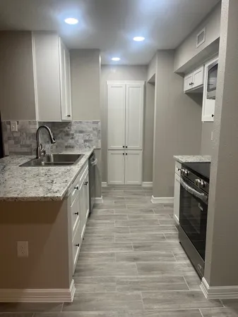 a kitchen with a sink and refrigerator