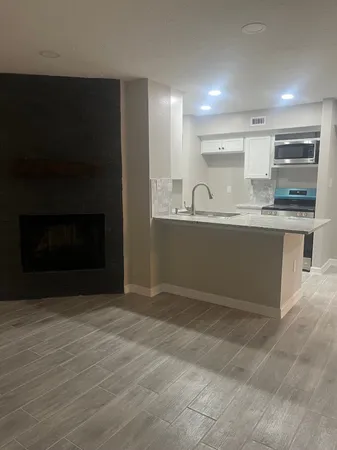 a view of kitchen with wooden floor and fireplace