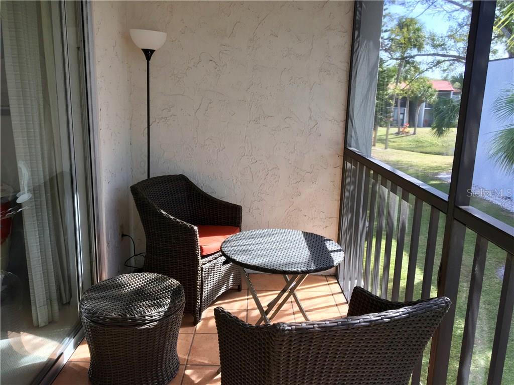 3213 South Beneva Road, Unit 204 Sarasota, FL 34232 - Photo 18 of 18 a table and chairs in a balcony