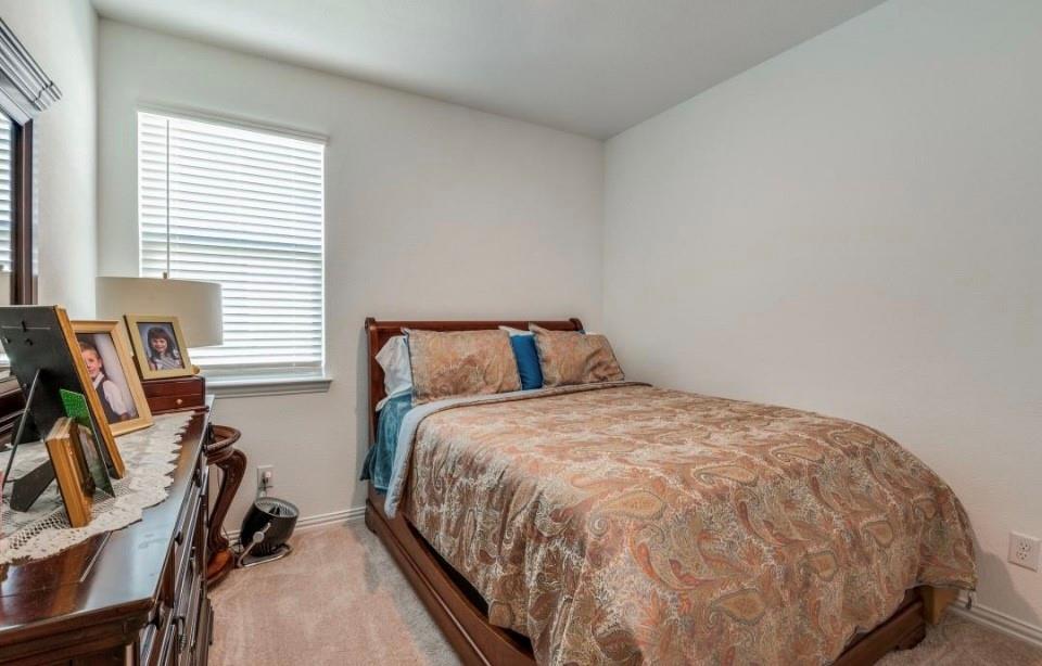 8424 Gray Squirrel Ln. McKinney, TX 75071 - Photo 10 of 22 a bed sitting in a bedroom next to a window
