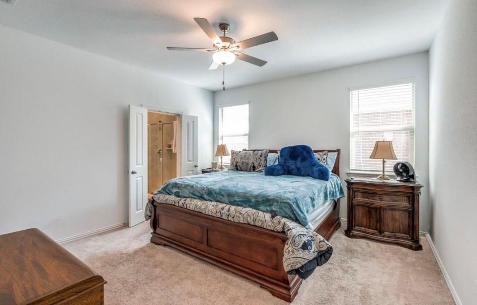 8424 Gray Squirrel Ln. McKinney, TX 75071 - Photo 11 of 22 a spacious bedroom with a bed and a chandelier