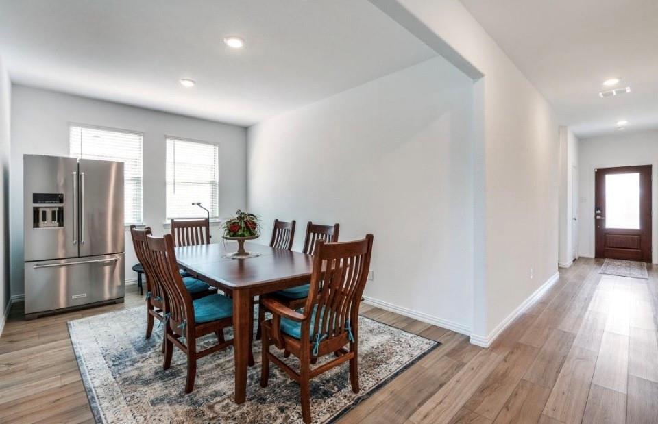 8424 Gray Squirrel Ln. McKinney, TX 75071 - Photo 2 of 22 a view of a dining room with furniture window and wooden floor