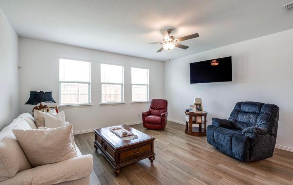 8424 Gray Squirrel Ln. McKinney, TX 75071 - Photo 4 of 22 a living room with furniture a flat screen tv and a window
