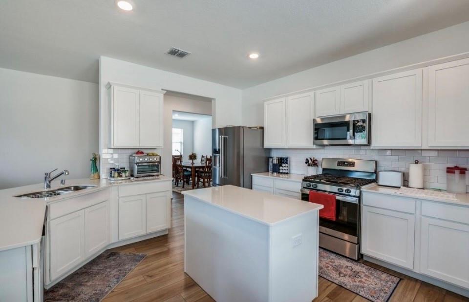8424 Gray Squirrel Ln. McKinney, TX 75071 - Photo 7 of 22 a kitchen with a sink stove top oven and refrigerator