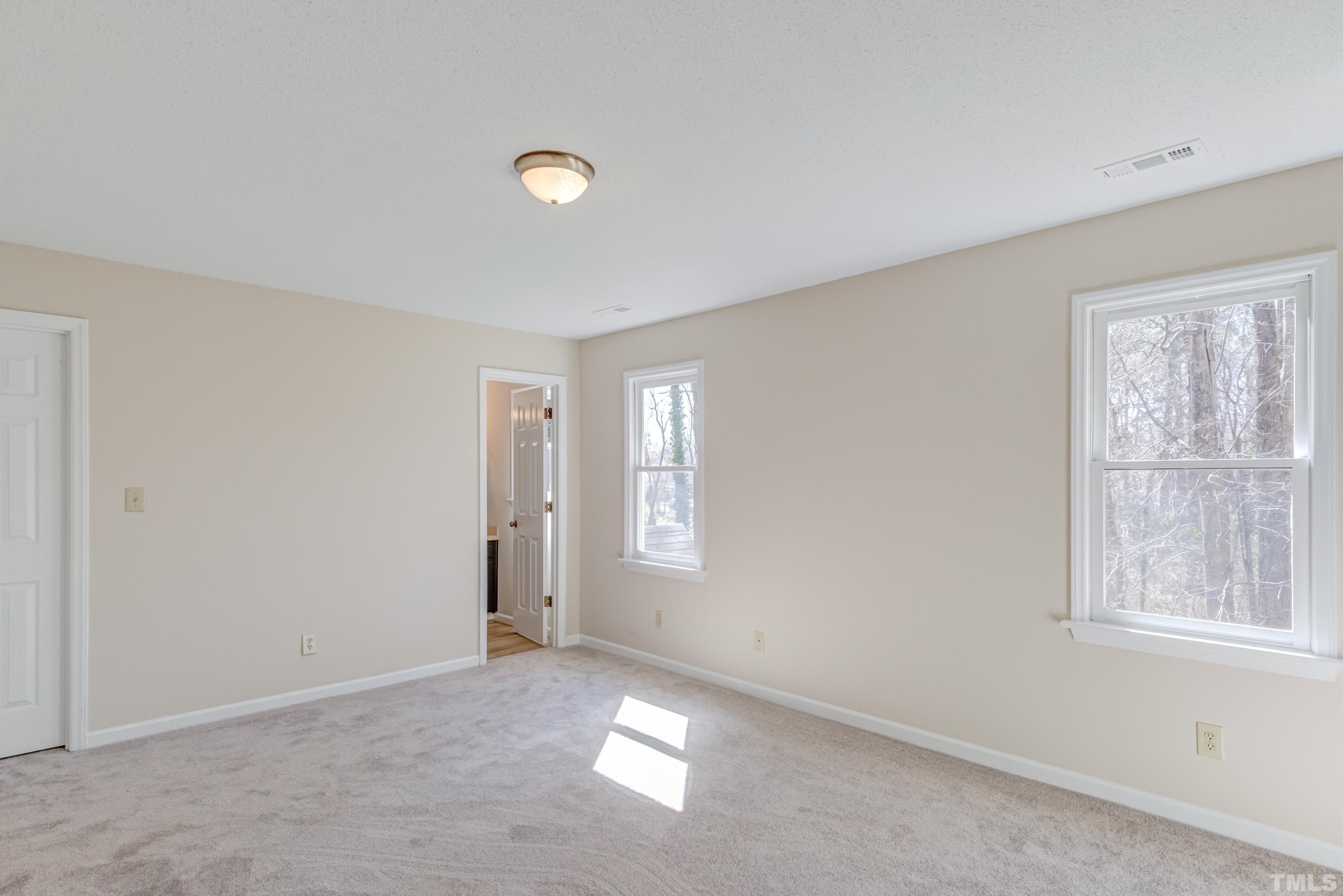 7307 Wilderness Road Raleigh, NC 27613 - Photo 11 of 14 an empty room with windows and closet