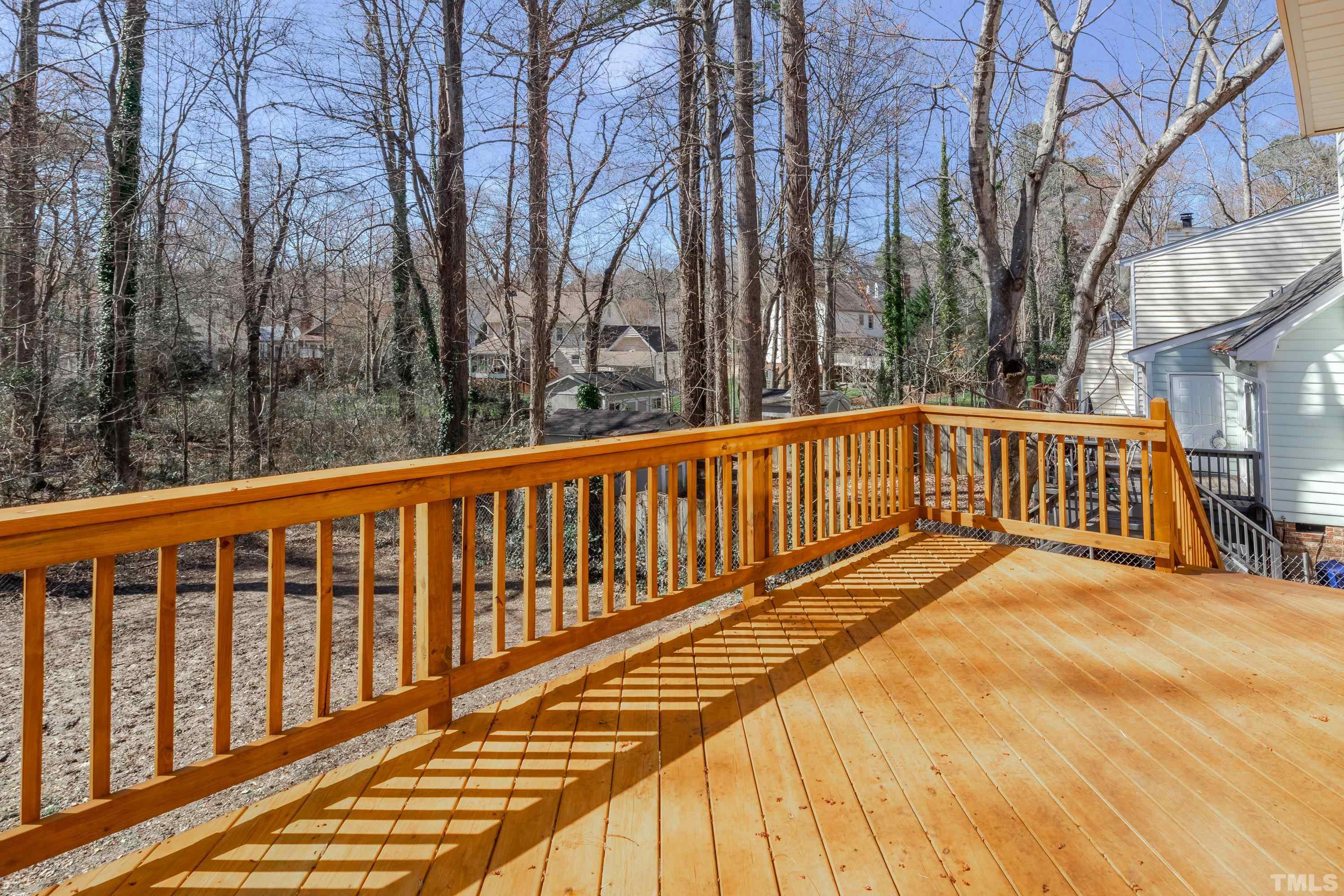 7307 Wilderness Road Raleigh, NC 27613 - Photo 14 of 14 a view of a balcony with wooden floor and fence