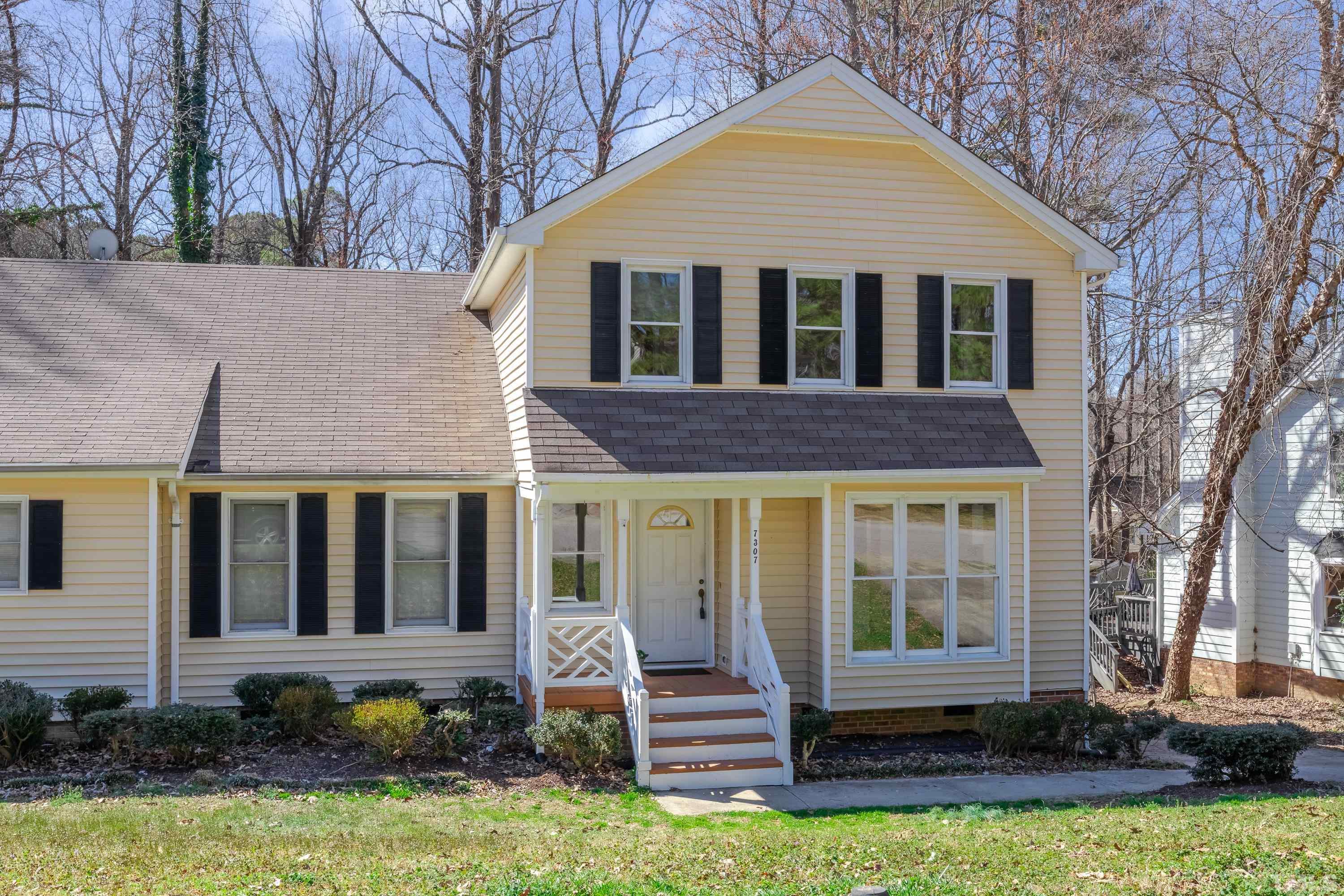 7307 Wilderness Road Raleigh, NC 27613 - Photo 2 of 14 a front view of a house with a yard