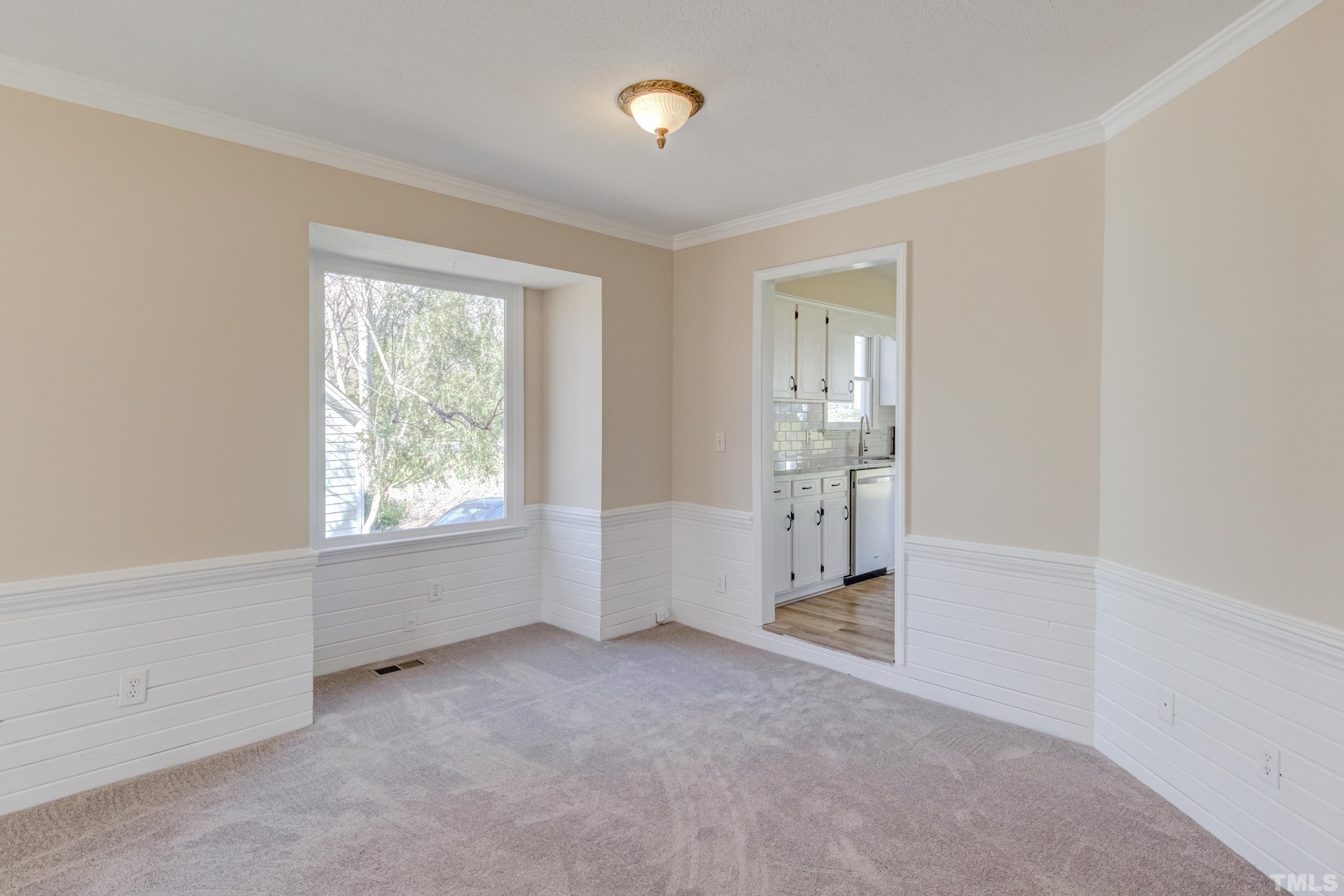7307 Wilderness Road Raleigh, NC 27613 - Photo 5 of 14 an empty room with windows