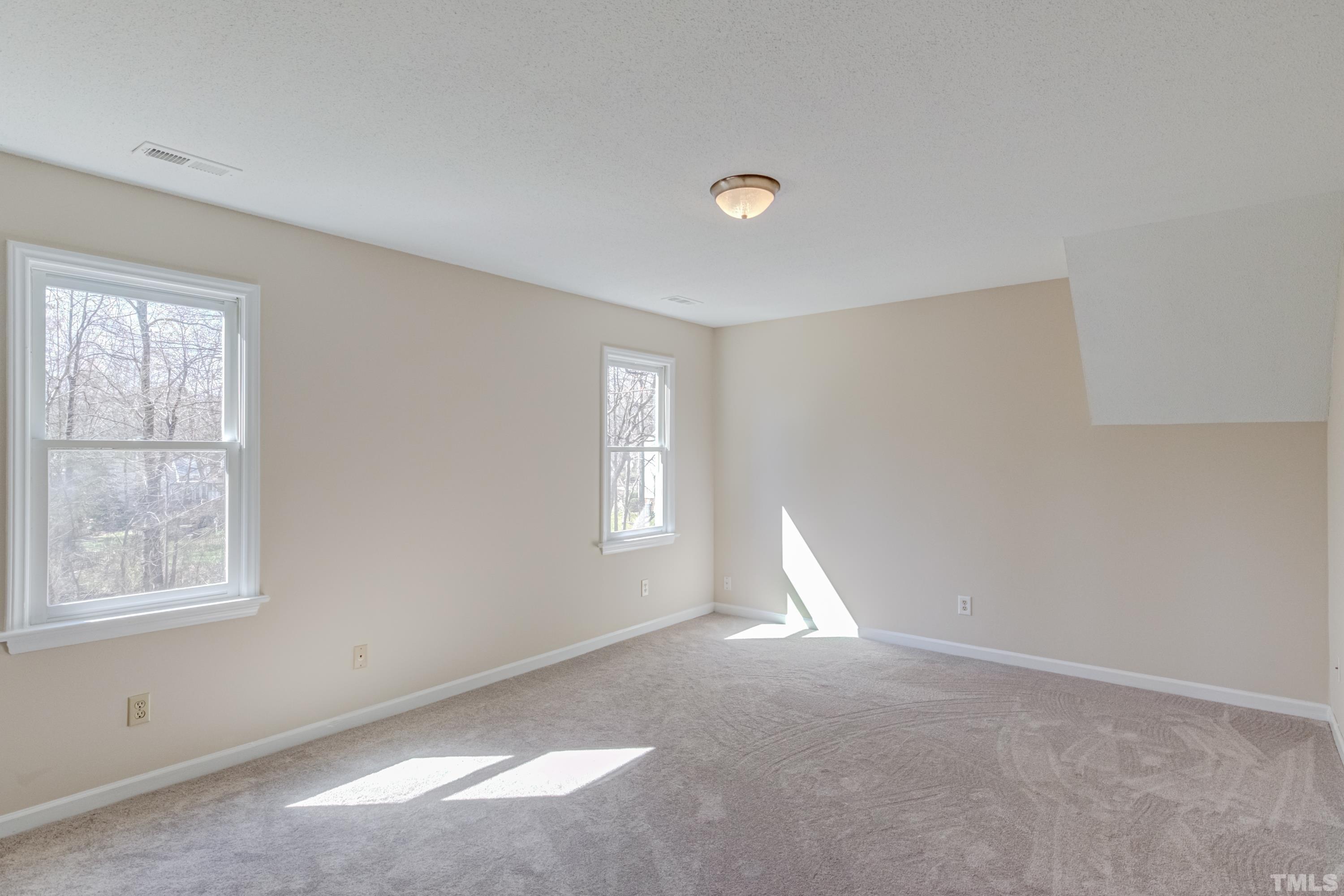 7307 Wilderness Road Raleigh, NC 27613 - Photo 10 of 14 an empty room with windows