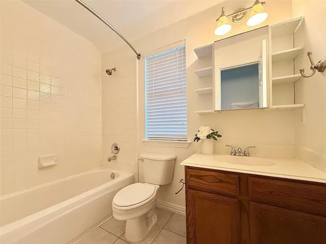 a bathroom with a sink toilet and a mirror