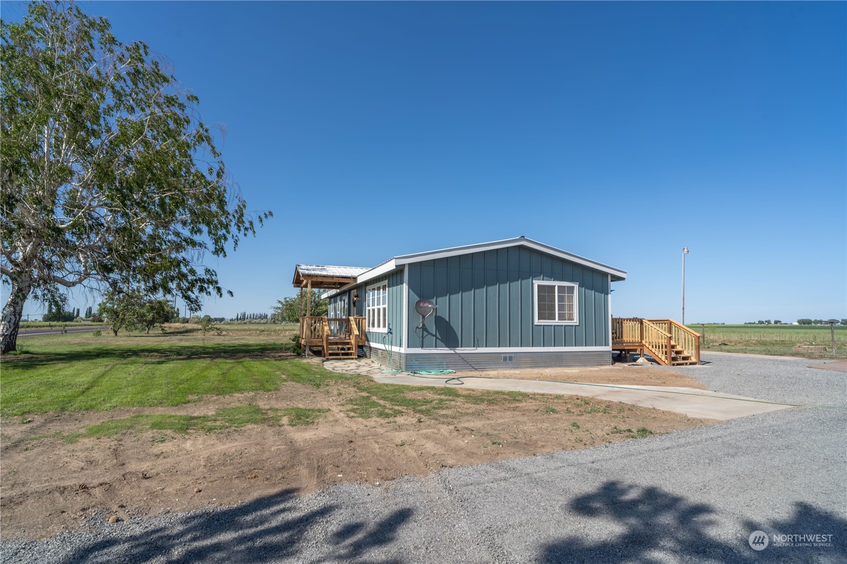 1963 Rd O Southeast Moses Lake, WA 98837 - Photo 4 of 18 a front view of a house with a yard and garage