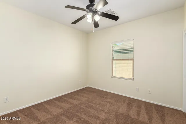 a view of a room with windows and ceiling fan