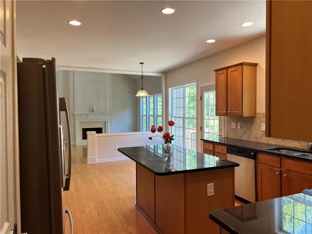 a kitchen with sink refrigerator and cabinets