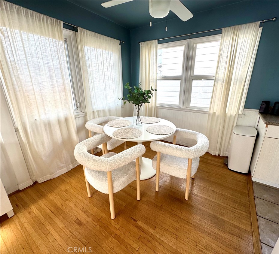 504 36th Street, Unit 1/2 Newport Beach, CA 92663 - Photo 5 of 15 a dining room with wooden floor and large windows