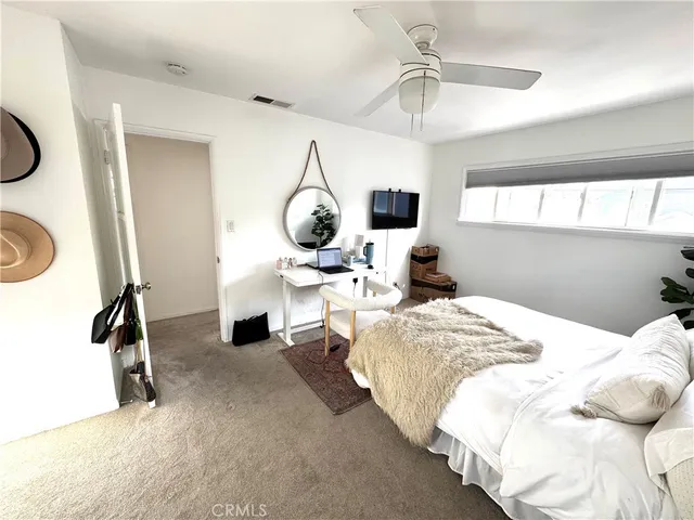 a bedroom with bed and a chandelier