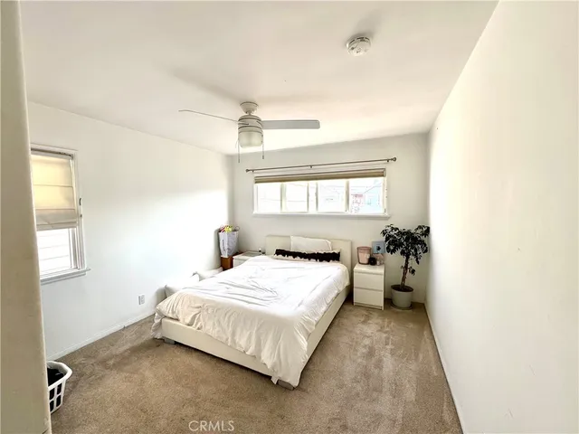 a bedroom with a bed and window