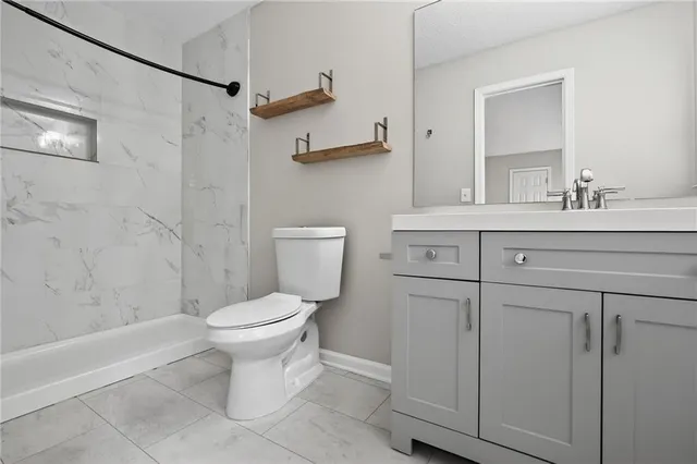 a bathroom with a sink toilet and shower