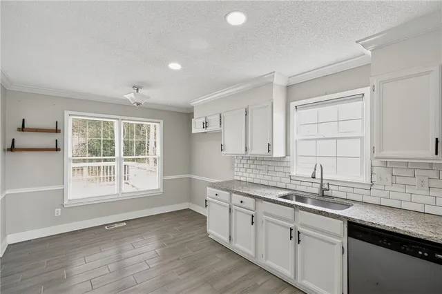 a kitchen with a sink cabinets and window