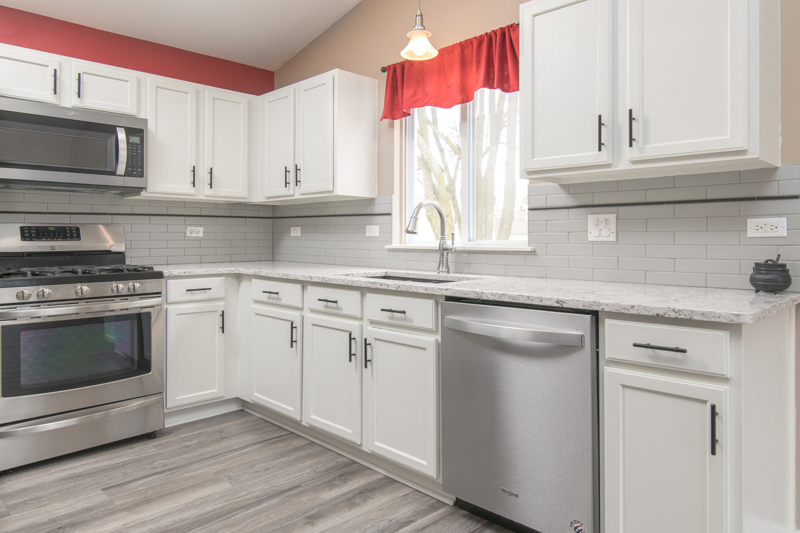 600 Indian Trail Road Antioch, IL 60002 - Photo 3 of 20 a kitchen with granite countertop white cabinets and stainless steel appliances
