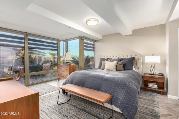 a bedroom with a large bed and a flat screen tv