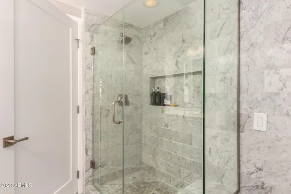 a bedroom with a bed and large window