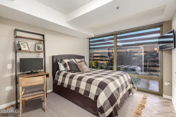 a bedroom with a bed and a window