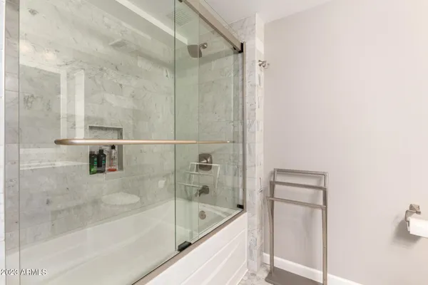 a view of roof deck with couches and potted plants