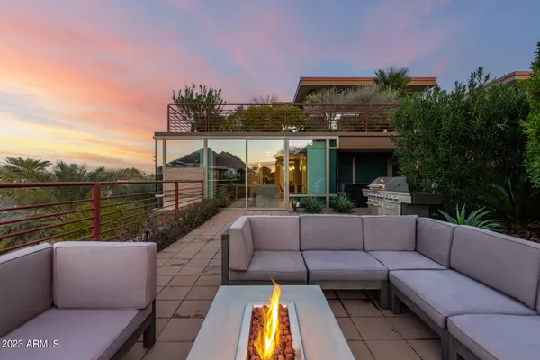 a view of a patio with couches chairs and a fire pit