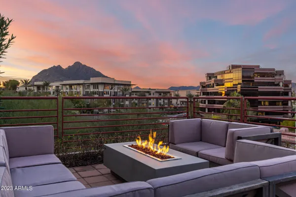 a backyard view of a house with sitting space and garden