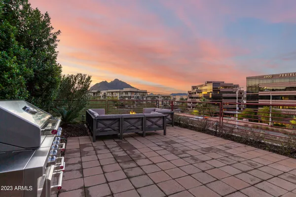 a view of a patio with table and chairs with wooden floor and fence