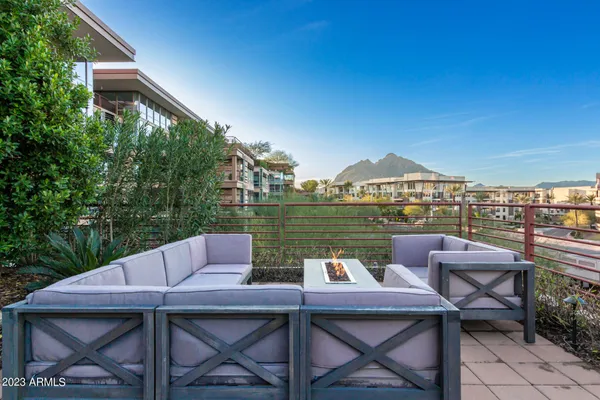 a view of a patio with table and chairs and potted plants