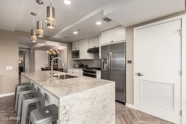 a view of a dining room with furniture and chandelier