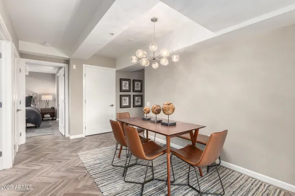 a dining room with furniture and chandelier