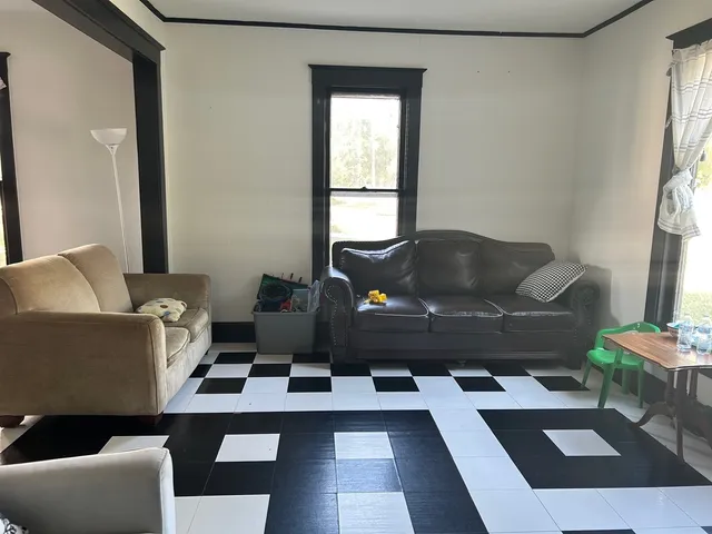 a living room with furniture and a window