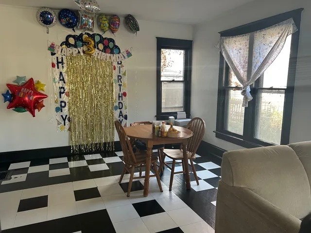a view of a dining room with furniture and window